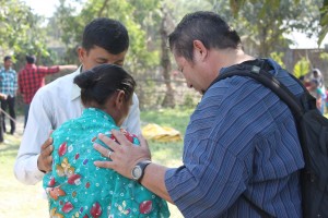 Bond Praying With a Woman After the Medical Clinic