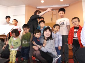Benjamin with Tokyo Chapel kids as they prayed for the kids who were advancing to the next grade.  Benjamin will be entering Kindergarten in August.